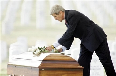 sen. john kerry, d-mass., places flowers on the coffin of u.s. marine lance cpl. geofrey r. cayer, 20, of fitchburg, mass., during a funeral ceremony at arlington national cemetery, wednesday, aug. 2, 2006, in arlington, va