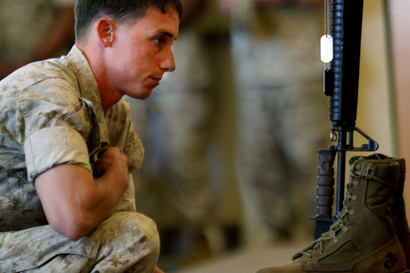a marine pays his respects during a memorial service for staff sgt. aaron j. taylor in the chapel at camp pendleton on october 28, 2009 in oceanside, california. staff sgt. taylor was killed while supporting combat operations in afghanistan.