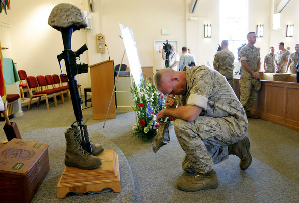 a marine pays his respects during a memorial service for staff sgt. aaron j. taylor in the chapel at camp pendleton on october 28, 2009 in oceanside, california. staff sgt. taylor was killed while supporting combat operations in afghanistan.
