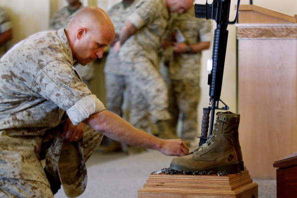 marine staff sgt. bryce cannon pays his respects during a memorial service for staff sgt. aaron j. taylor in the chapel at camp pendleton on october 28, 2009 in oceanside, california. staff sgt. taylor was killed while supporting combat operations in afghanistan.