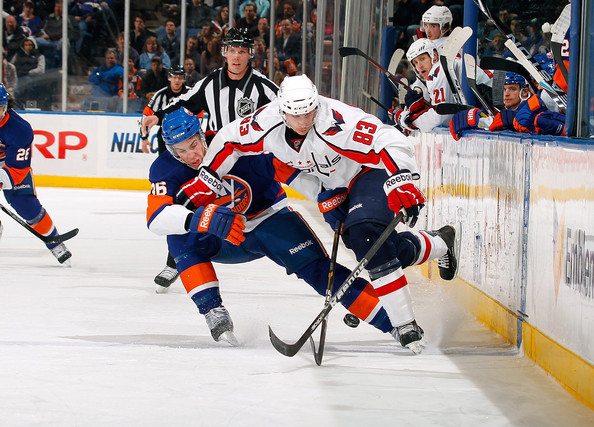 jay beagle jay beagle #83 of the washington capitals skates for the puck against travis hamonic #36 of the new york islanders on january 20, 2011 at nassau coliseum in uniondale, new york.