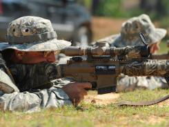 pfc. robert hamersly, left, and pfc. michael trischler shoot at targets at the army\'s sniper school.