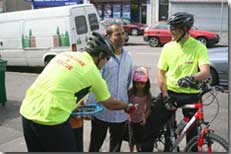 two firefighters on bikes give out safety advice in the community