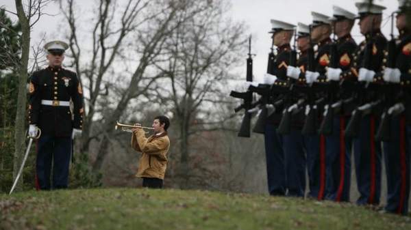 steven rosales, 18, of mason plays taps at the rosehill cemetery in eaton rapids, mich., where marine lance cpl. troy nealey was laid to rest.