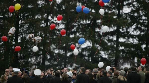 friends and family members release balloons in memory of marine lance cpl. troy nealey who was laid to rest at the rosehill cemetery in eaton rapids.