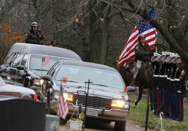 the hearse carrying marine lance cpl. troy nealey arrives at the rosehill cemetery.