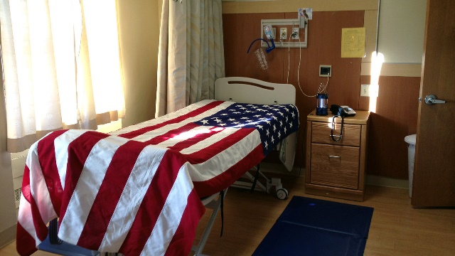 a hospital bed is draped with a flag after a veteran died in the hospice ward at st. albans va in queens, n.y.