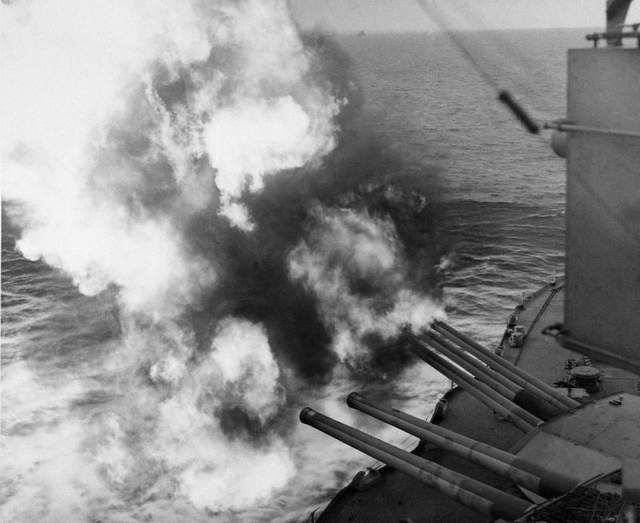 mushrooms of smoke and flame billow out from the giant uss nevada as the battleship provides artillery support for allied ground forces in france by hammering enemy installations from the english channel on d-day, june 6, 1944.