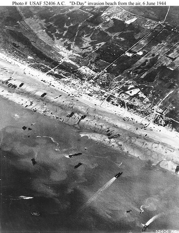 d-day beach traffic, photographed from a ninth air force bomber. note vehicle lanes leading away from the landing areas, and landing craft left aground by the tide.