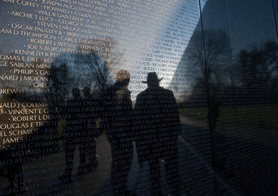 a vietnam veteran is reflected in the vietnam war memorial wall before a ceremony to mark the 50th anniversary of the vietnam war on march 29.