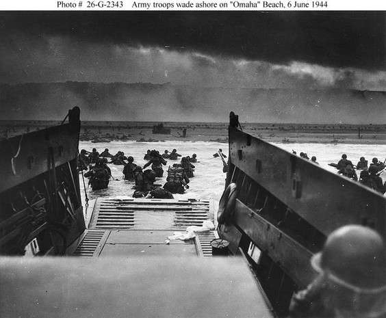army troops wade ashore on omaha beach during the d-day landings. they were brought to the beach by a coast guard manned lcvp.