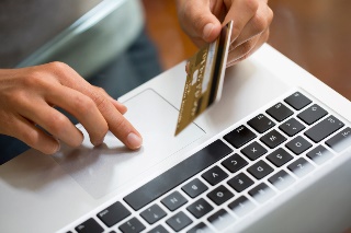 http://www.cheatsheet.com/wp-content/uploads/2015/07/close-up-hand-woman-using-laptop-and-credit-card-online-shopping.jpg