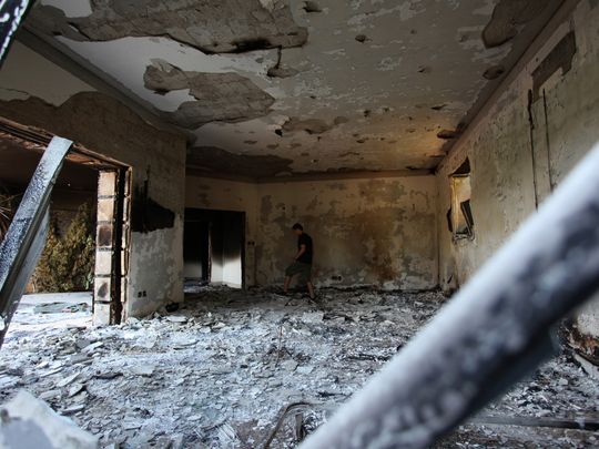 a man walks through the rubble of the u.s. consular