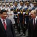 resident xi jinping of china, left, with president vladimir v. putin of russia at a regional summit meeting in shanghai last month. a report says mr. xi has pursued a complicated, if not contradictory, course of assertiveness and conciliation.
